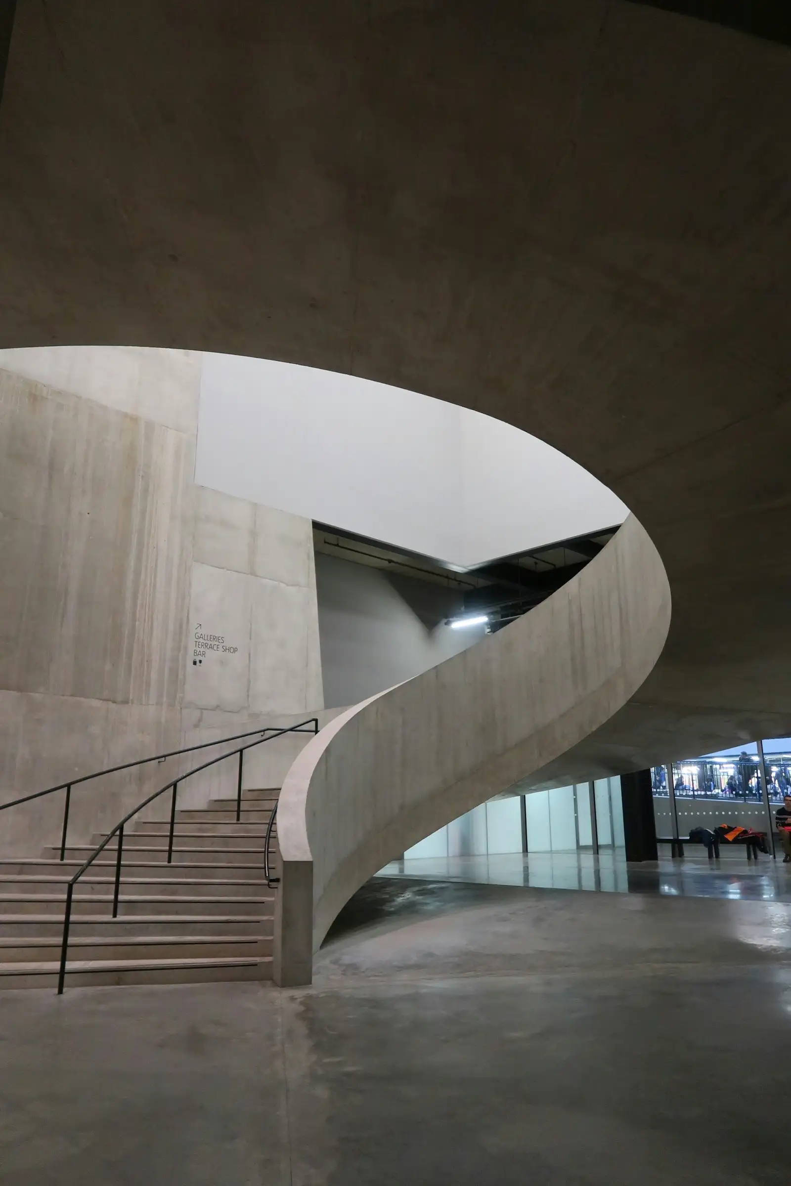 Curved concrete staircase inside a modern building